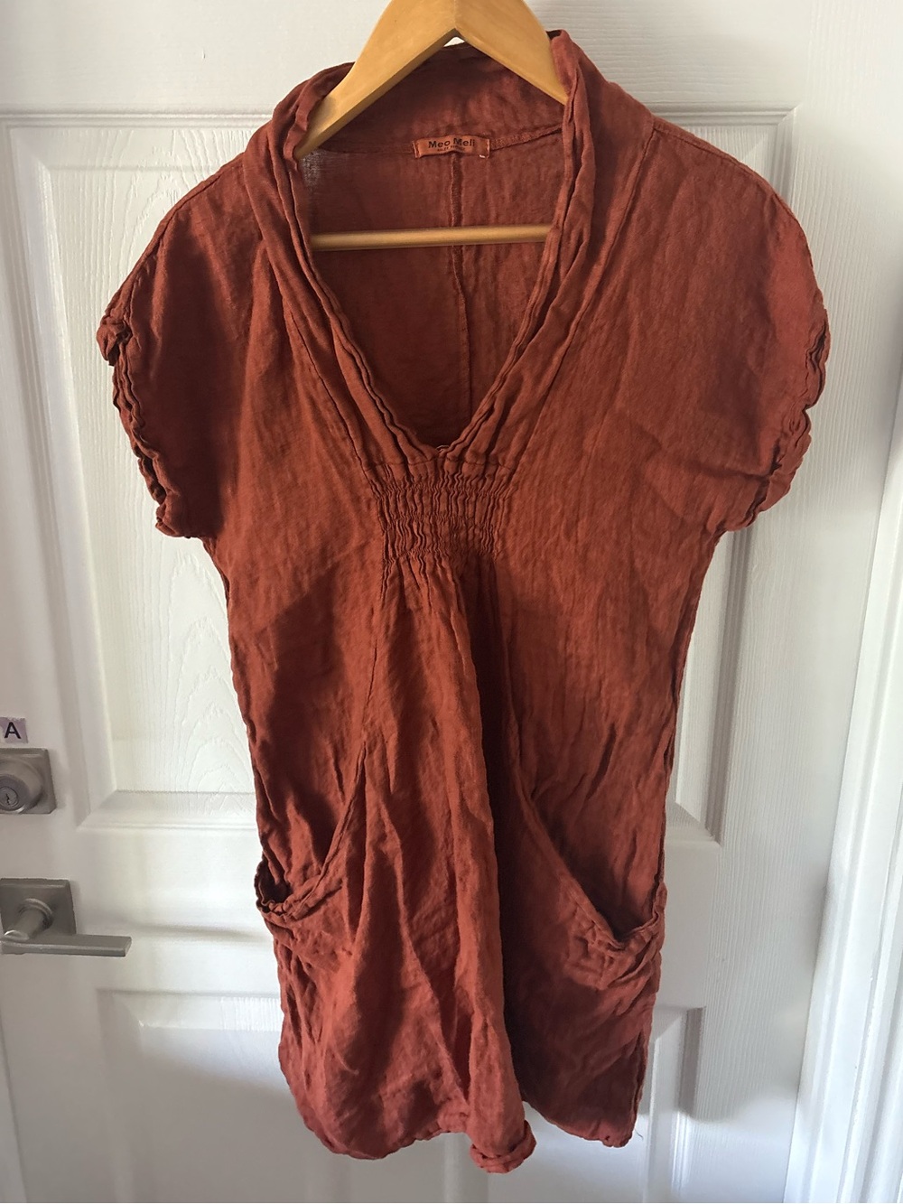 Meo Meli linen dress features ruched chest detailing and a rust-colored fabric